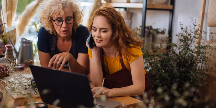 Two people looking at a computer